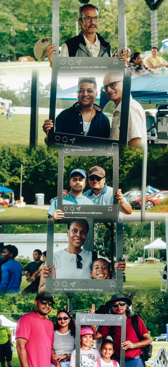 Festival guests and families posing with the Live At Present photo frame